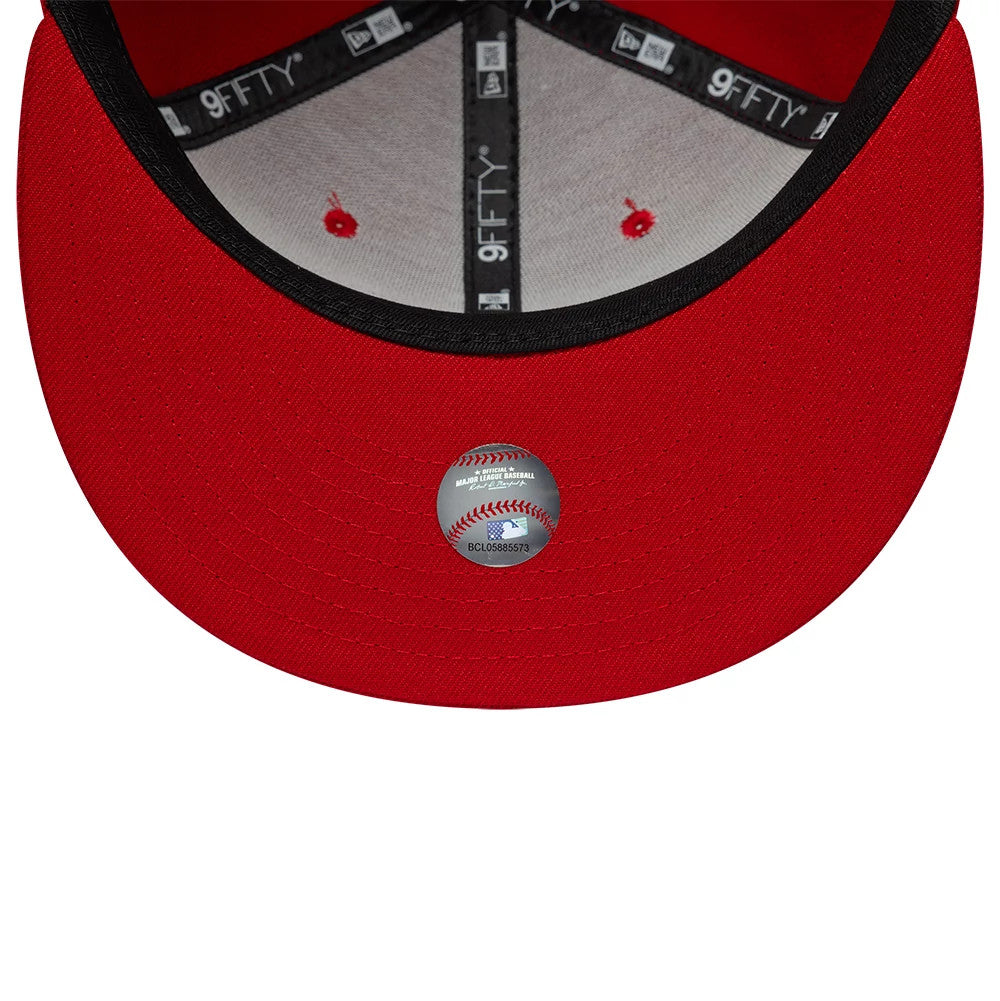 Philadelphia Phillies MLB Upside Down Red New Era 9FIFTY Snapback Cap, inside view showing the black taping with white 9FIFTY lettering, grey sweatband, and a baseball-themed sticker on the red undervisor near the edge of the cap.
