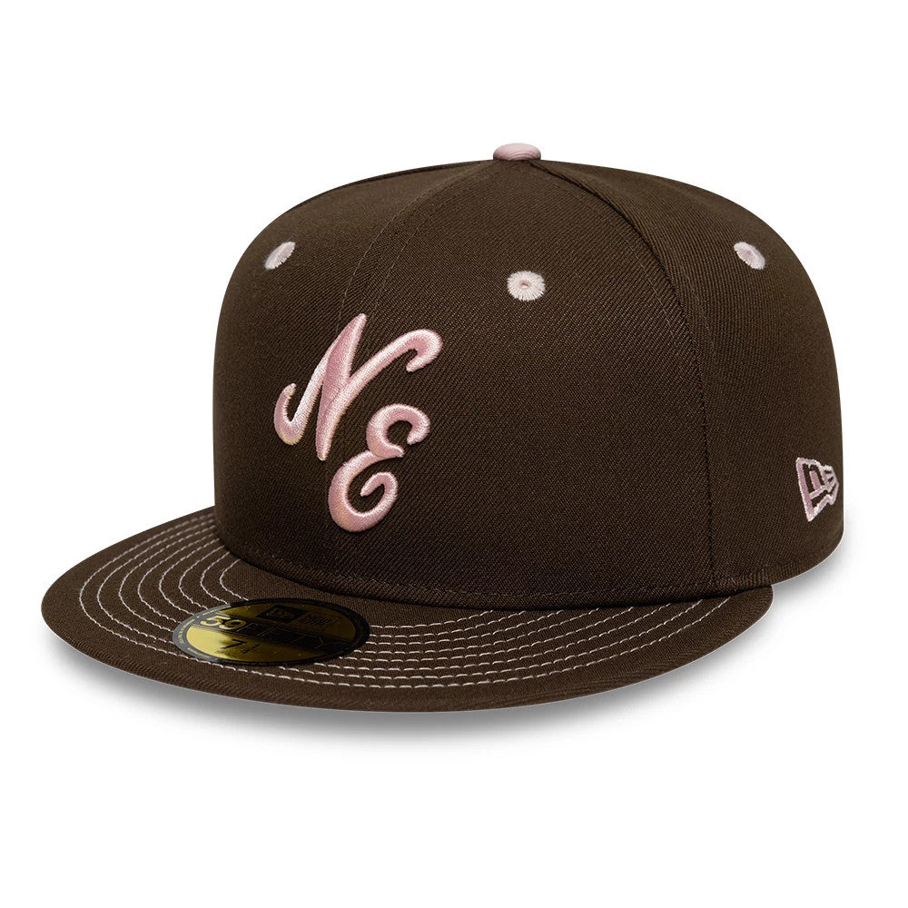 New Era With Love Dark Brown 59FIFTY Fitted Cap, front view showing pink cursive NE logo embroidered on the front panels, brown flat visor with pink contrast stitching, and gold 59FIFTY size sticker displaying on the visor.