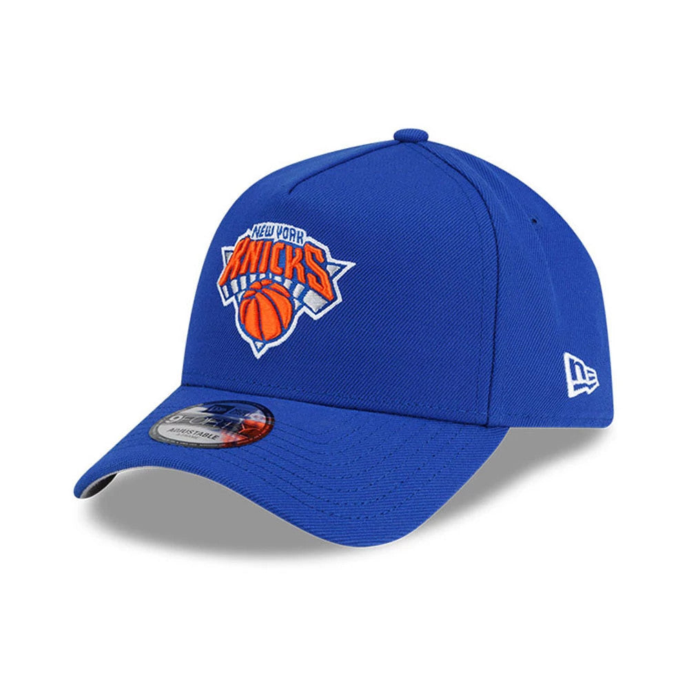 New York Knicks NBA Champs 2025 - 2026 Blue New Era 9FORTY A-Frame Adjustable Cap, three-quarter view showing the raised embroidered Knicks logo on the structured blue crown, curved blue visor, silver 9FORTY size sticker.