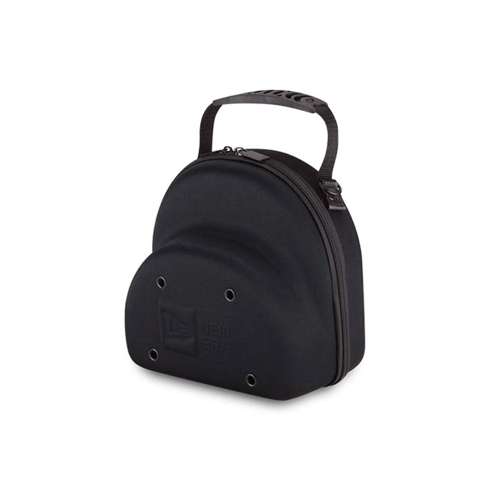 New Era Black 2 Cap Carry Case, three-quarter view showing the debossed New Era logo on the front, a row of eyelets below, a zip closure on the side of the rounded black shell, and a short handle on top.