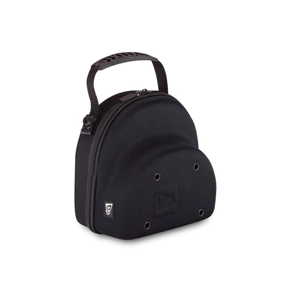 New Era Black 2 Cap Carry Case, three-quarter view showing the rounded black shell with eyelets on the front, a debossed New Era logo beneath them, and a short carry handle attached to the top with a side zip closure.