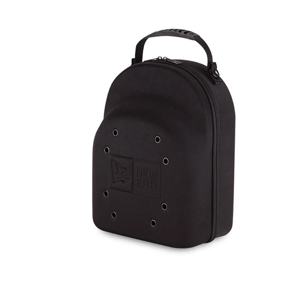 New Era 6 Pack Black Cap Carrier, three-quarter view showing the black shell with a debossed New Era logo on the front, eyelets arranged around the logo, and a zip closure running alongside the top handle.