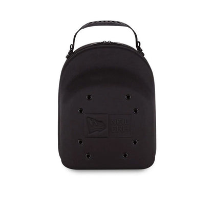 New Era 6 Pack Black Cap Carrier, front view showing the black shell with a debossed New Era logo centred on the lower half, a carry handle attached at the top and eyelets evenly distributed across the front above the logo.