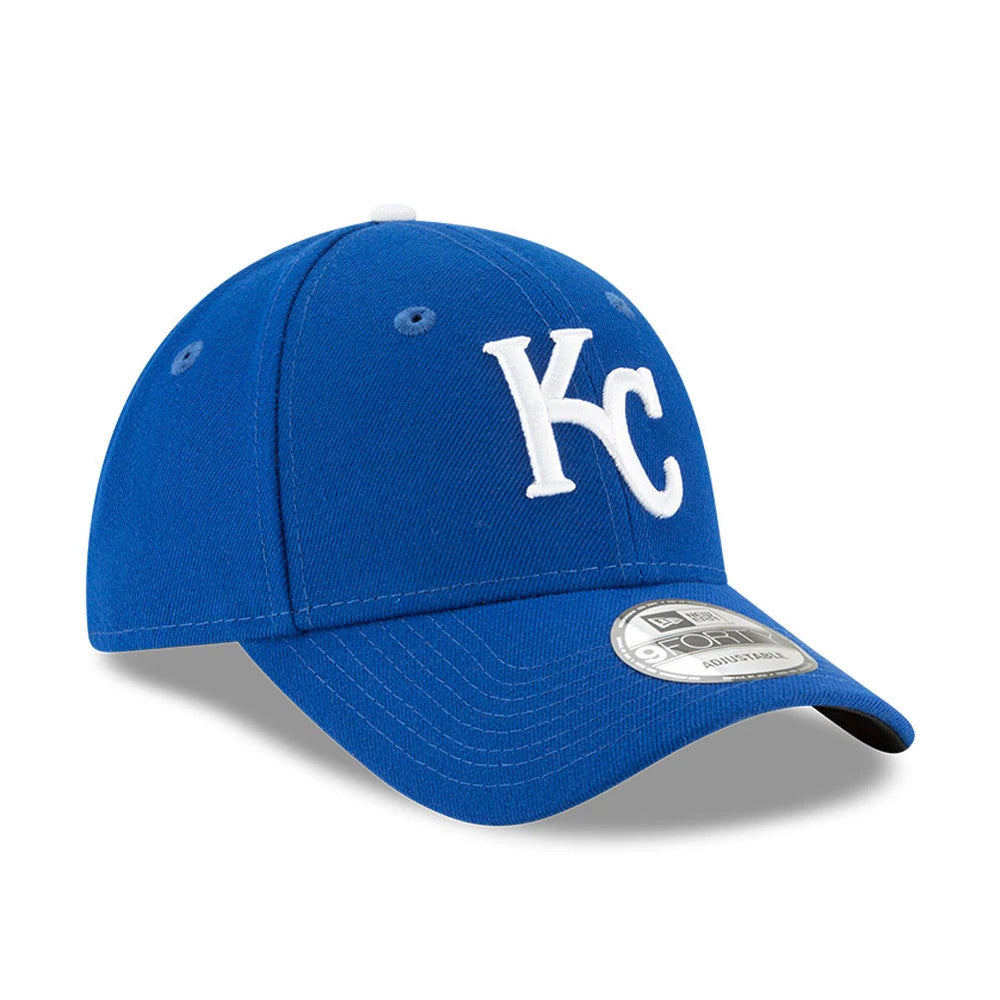 Kansas City Royals The League Blue New Era 9FORTY Cap, three-quarter view showing a white embroidered KC logo on the front panel, curved visor with a 9FORTY size sticker, and matching blue eyelets and top button.