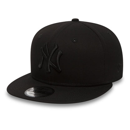 New York Yankees Black On Black New Era 9FIFTY Cap, three-quarter view showing the black embroidered NY logo on the front panel, with black flat visor and 9FIFTY size sticker, plus New Era flag logo on the left side.