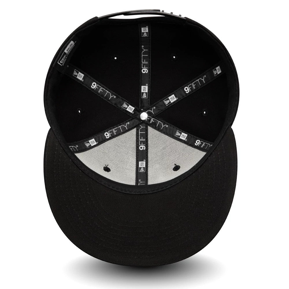 New Era All Black 9FIFTY Cap, inside view showing black and grey taping with repeating 9FIFTY logos, and a central white top button on the interior, with black fabric lining and matching black sweatband.