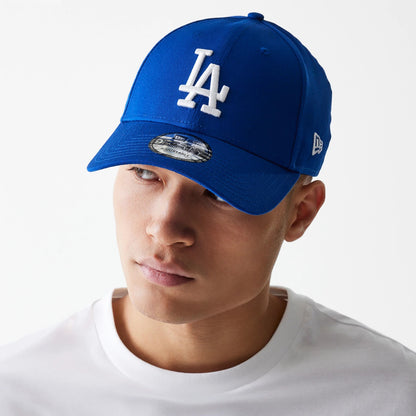 LA Dodgers Essential Blue New Era 9FORTY Cap, on-model front view with a white LA logo in raised embroidery on the blue front panel, a curved visor, 9FORTY size sticker and New Era flag logo on the left side.