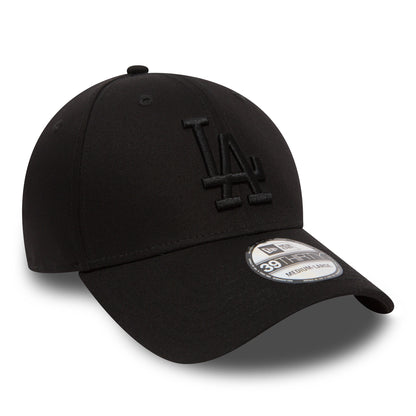 LA Dodgers Essential Black On Black New Era 39THIRTY Cap, three-quarter view showing raised black LA logo embroidery on the front panel, with a 39THIRTY size sticker on the curved visor and a matching top button.