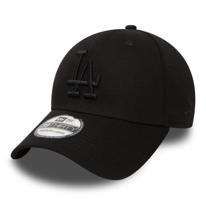 LA Dodgers Essential Black On Black New Era 39THIRTY Cap, three-quarter view showing raised black LA embroidery on the front panel, a black curved visor with a 39THIRTY size sticker, and the New Era flag logo on the left side.