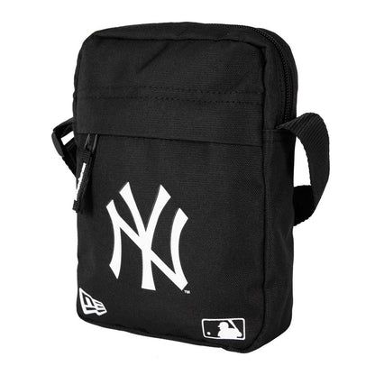 New York Yankees Black Side Bag, three-quarter view showing the black rectangular shape with a white raised Yankees logo on the front, a black zip closure at the top, and a long black shoulder strap attached at the side.