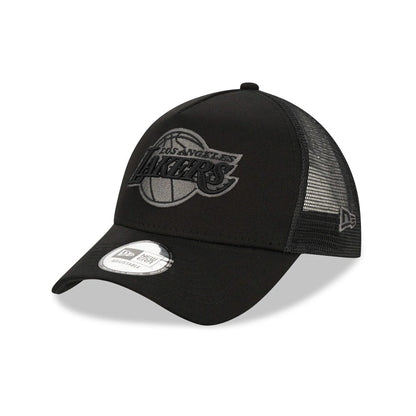 LA Lakers Tonal Black New Era A-Frame Trucker Cap, three-quarter view showing the raised tonal Lakers logo on the front panel, black mesh side panels with the New Era flag logo, and a 9FORTY size sticker on the black curved visor.