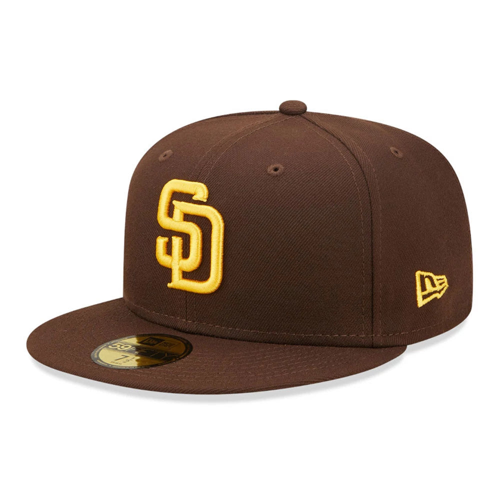 San Diego Padres Authentic On Field Brown New Era 59FIFTY Cap, three-quarter view showing the raised yellow SD logo on the front panel, brown flat visor with gold 59FIFTY size sticker, and yellow New Era flag logo on the left side.