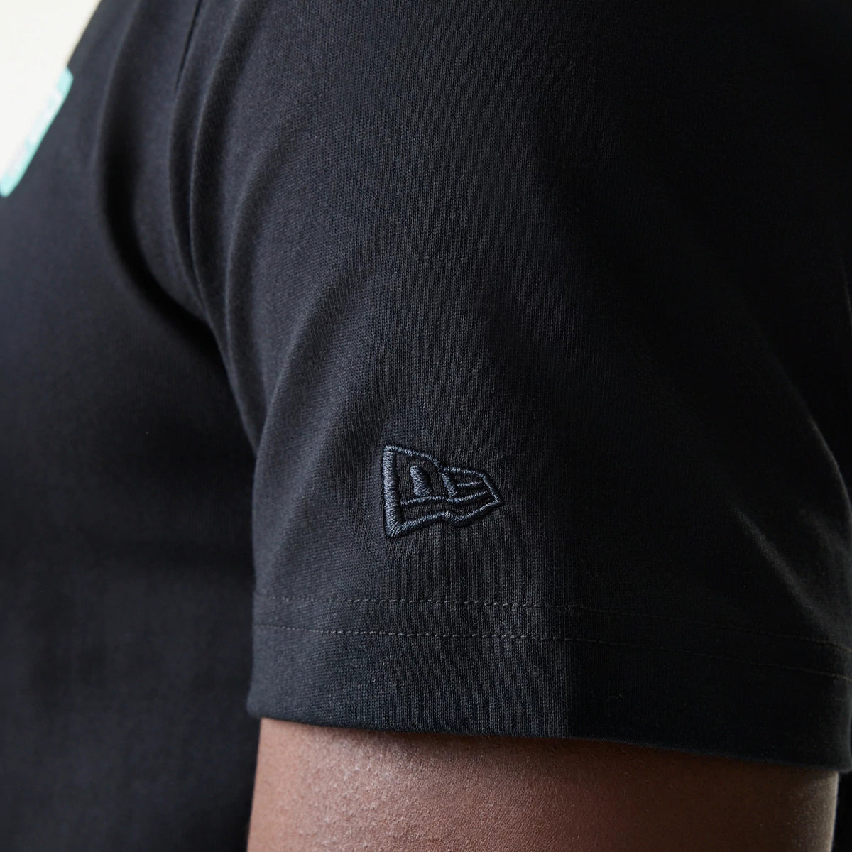 The Male model is wearing New Era Classic Black T-Shirt 7