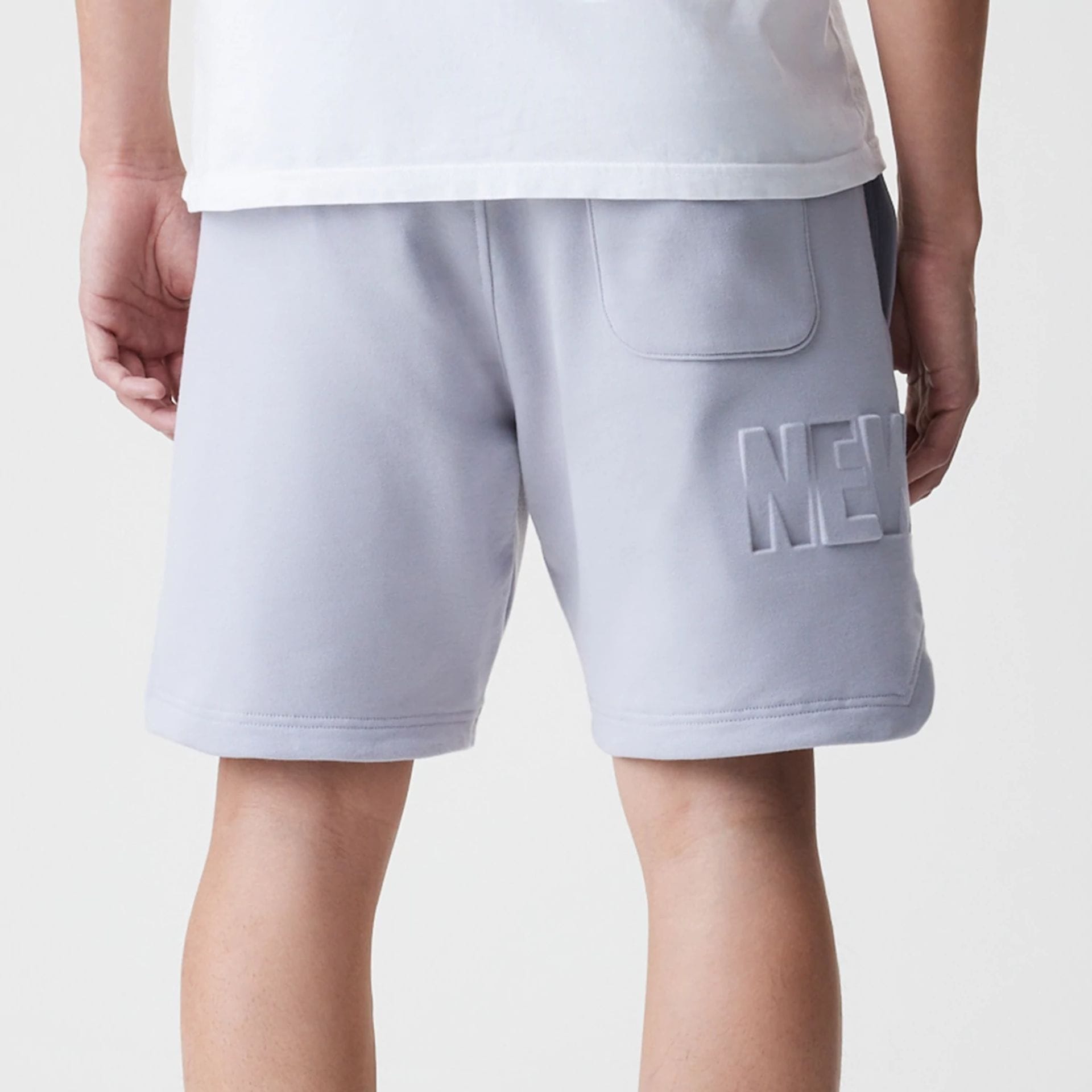 The Male model is wearing New Era Tonal Pack Grey Shorts 7