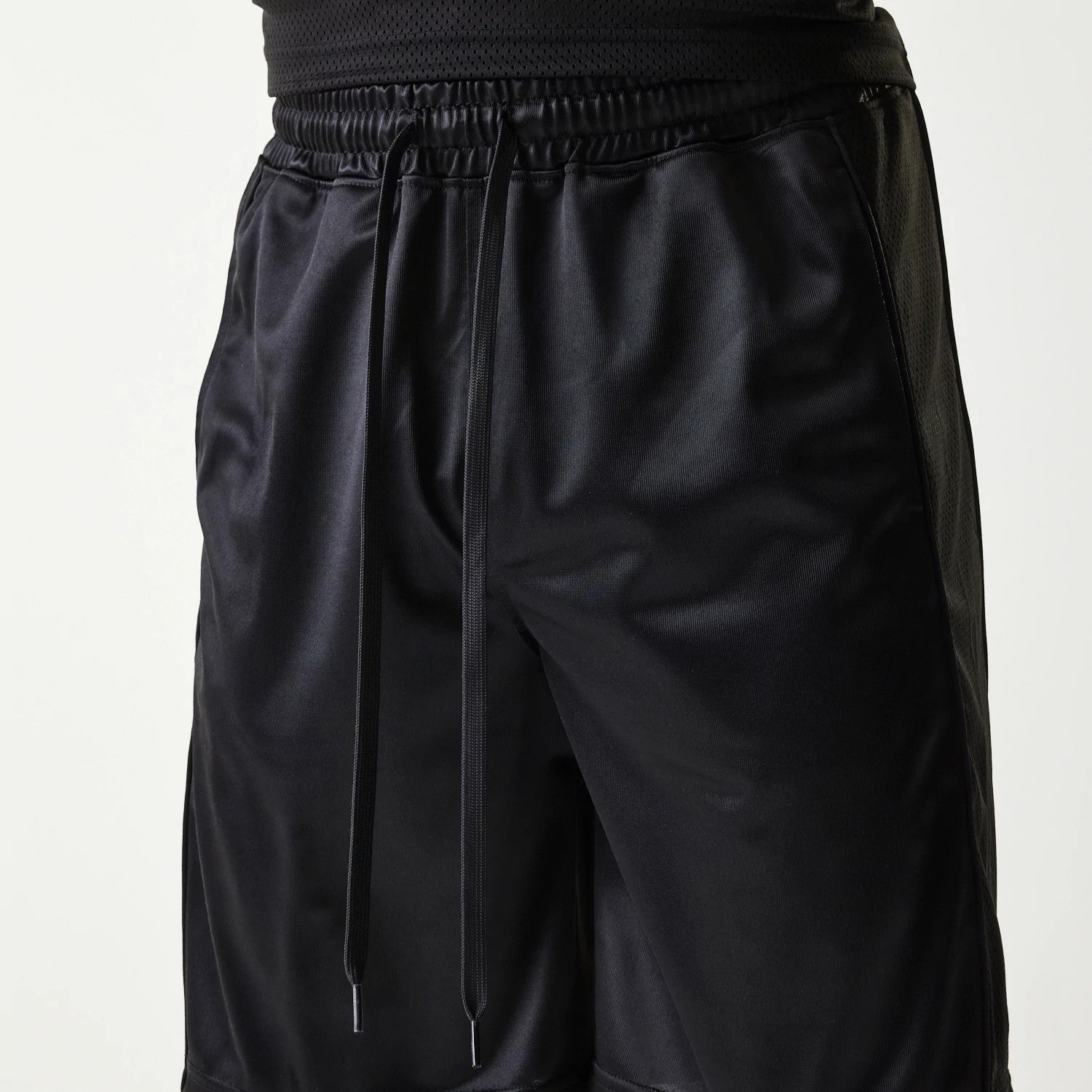 The Male model is wearing New Era Retro Sports Black Mesh Shorts 3