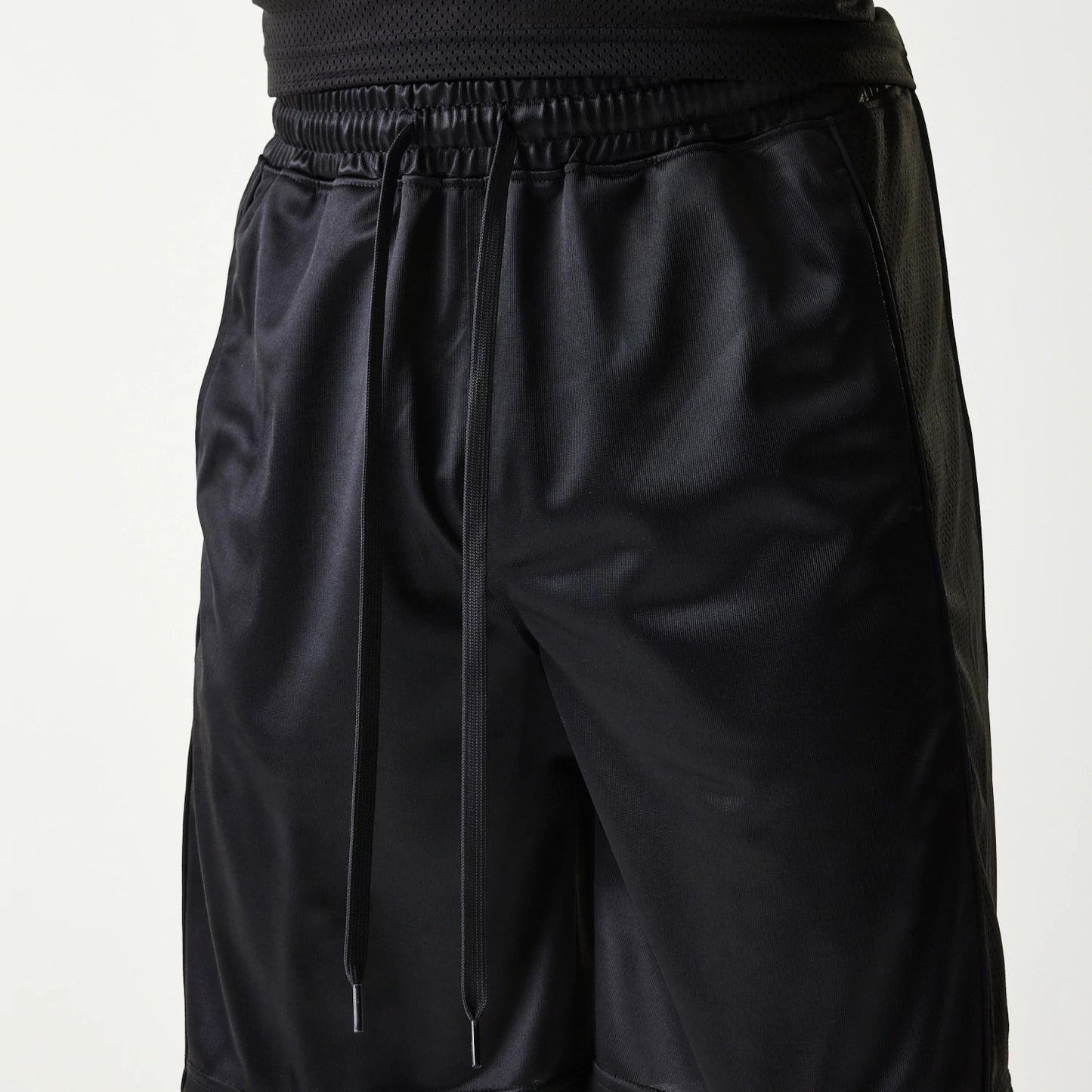 The Male model is wearing New Era Retro Sports Black Mesh Shorts 3