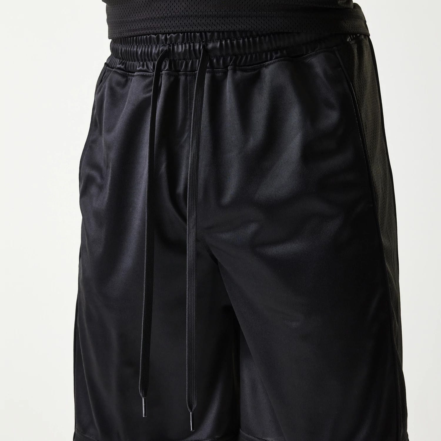 The Male model is wearing New Era Retro Sports Black Mesh Shorts 3