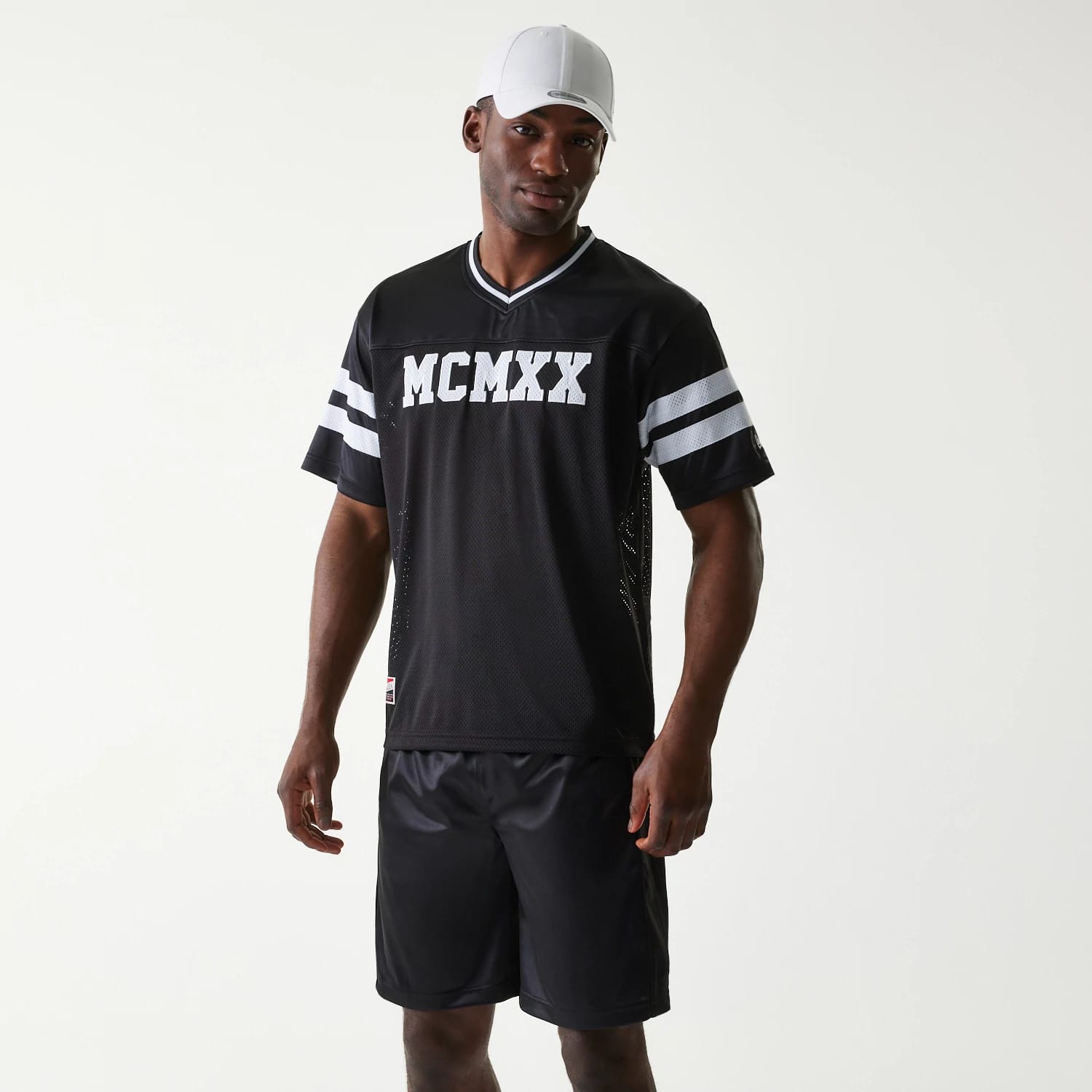 The Male model is wearing New Era Retro Sports Black Mesh Jersey 1
