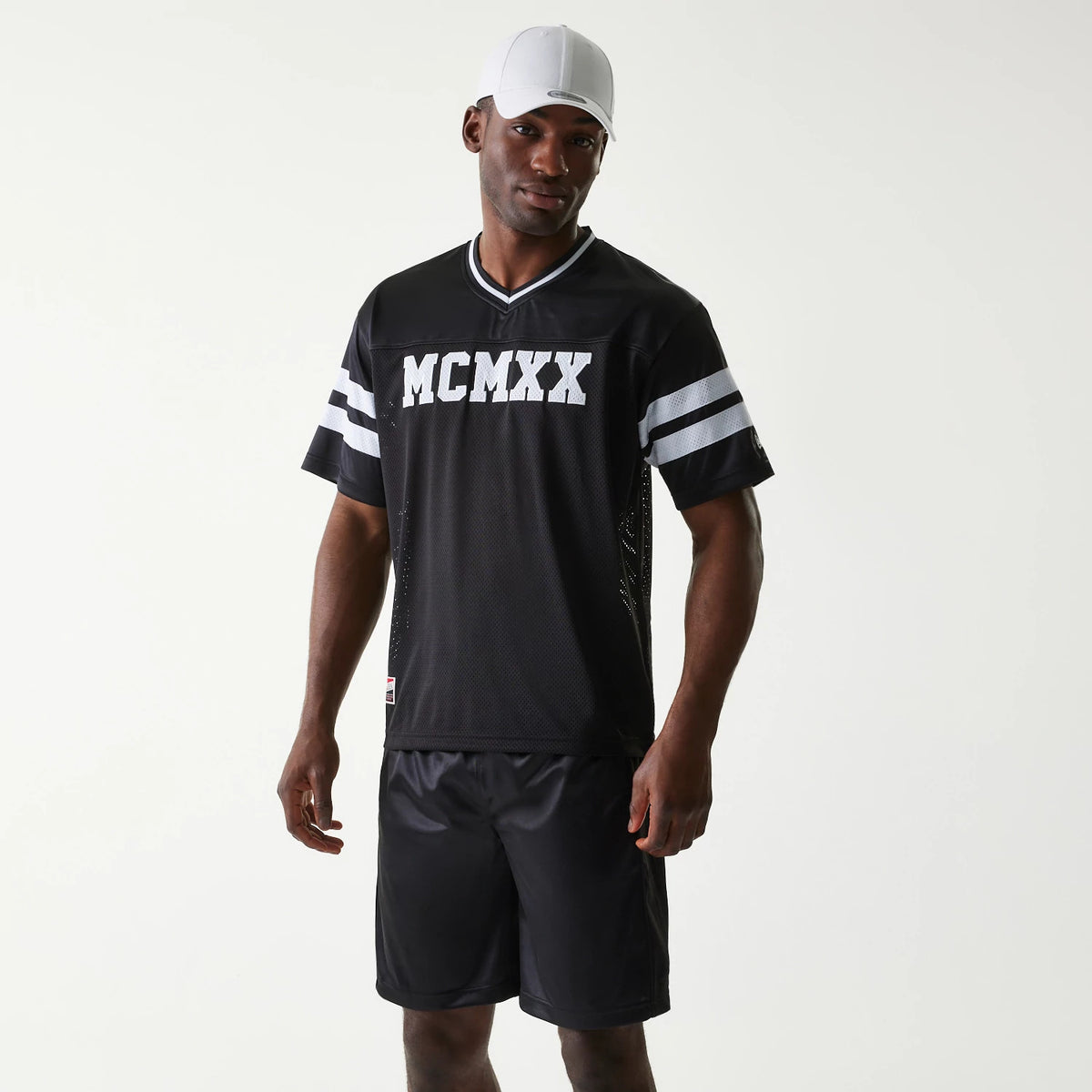 The Male model is wearing New Era Retro Sports Black Mesh Jersey 1