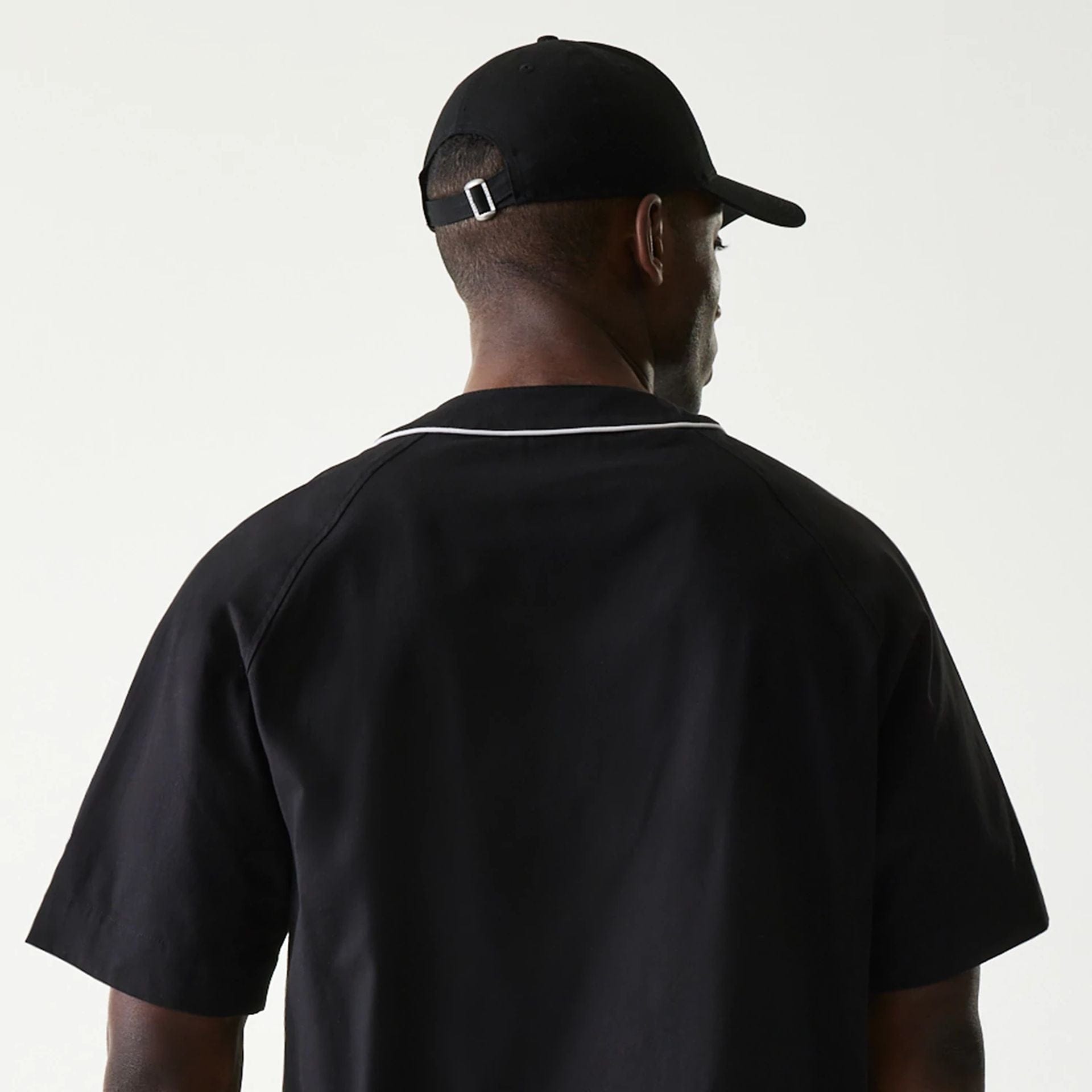 The Male model is wearing New Era Retro Baseball Black Short Sleeve Shirt 7