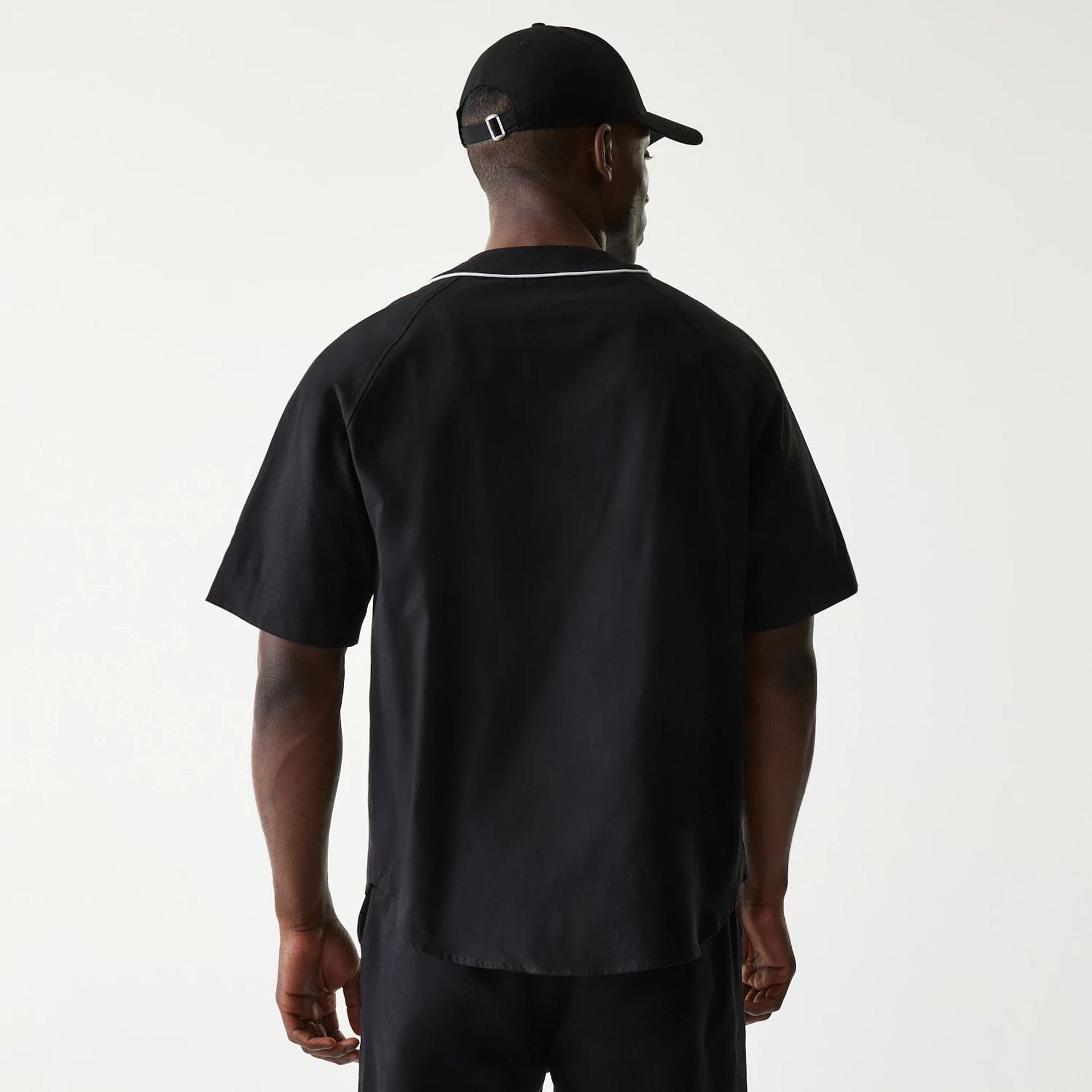 The Male model is wearing New Era Retro Baseball Black Short Sleeve Shirt 2