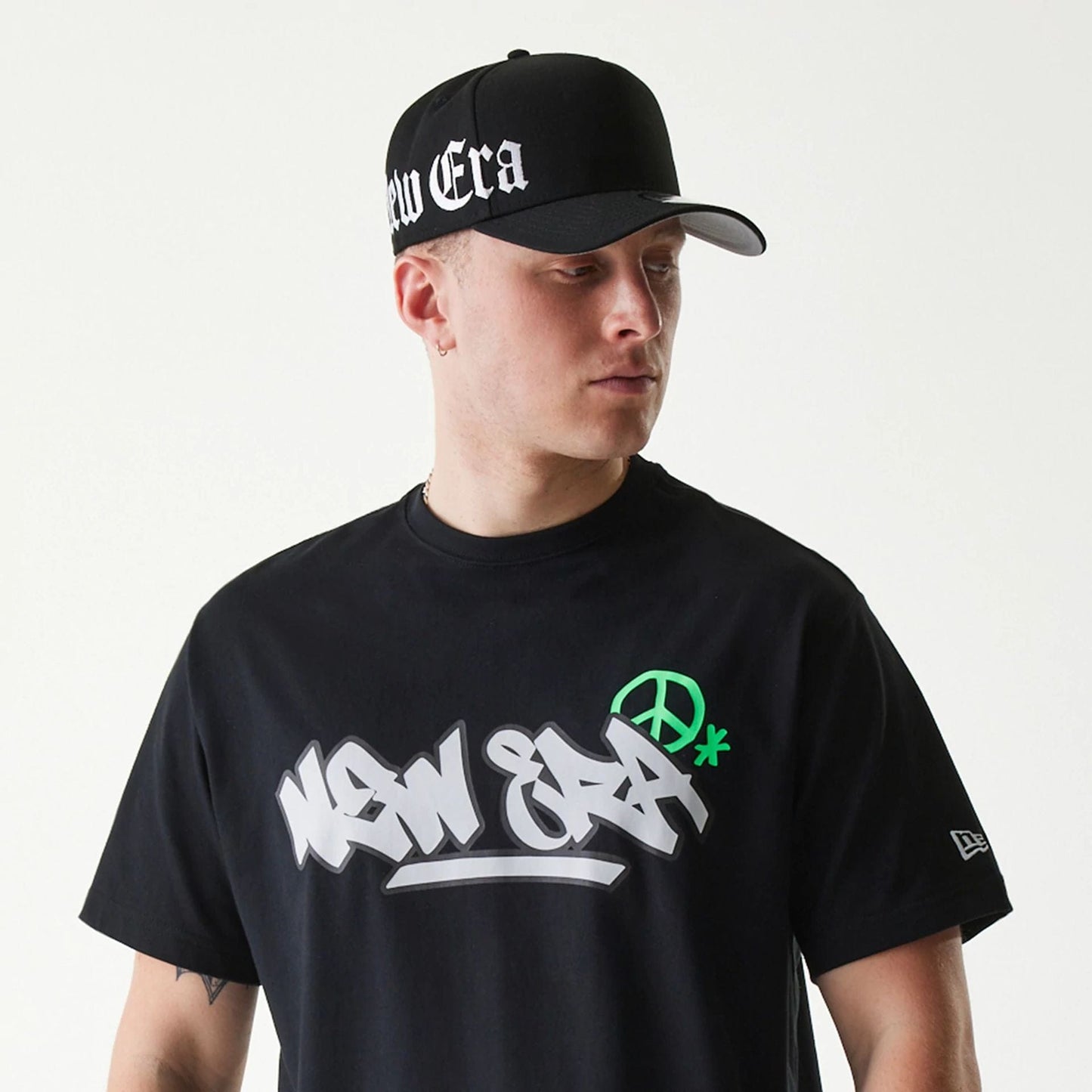 The Male model is wearing New Era Peace Symbol Black T-Shirt 6