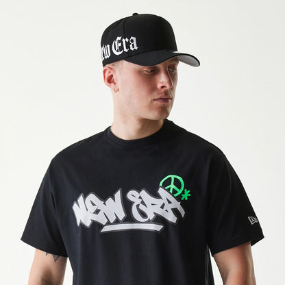 The Male model is wearing New Era Peace Symbol Black T-Shirt 6
