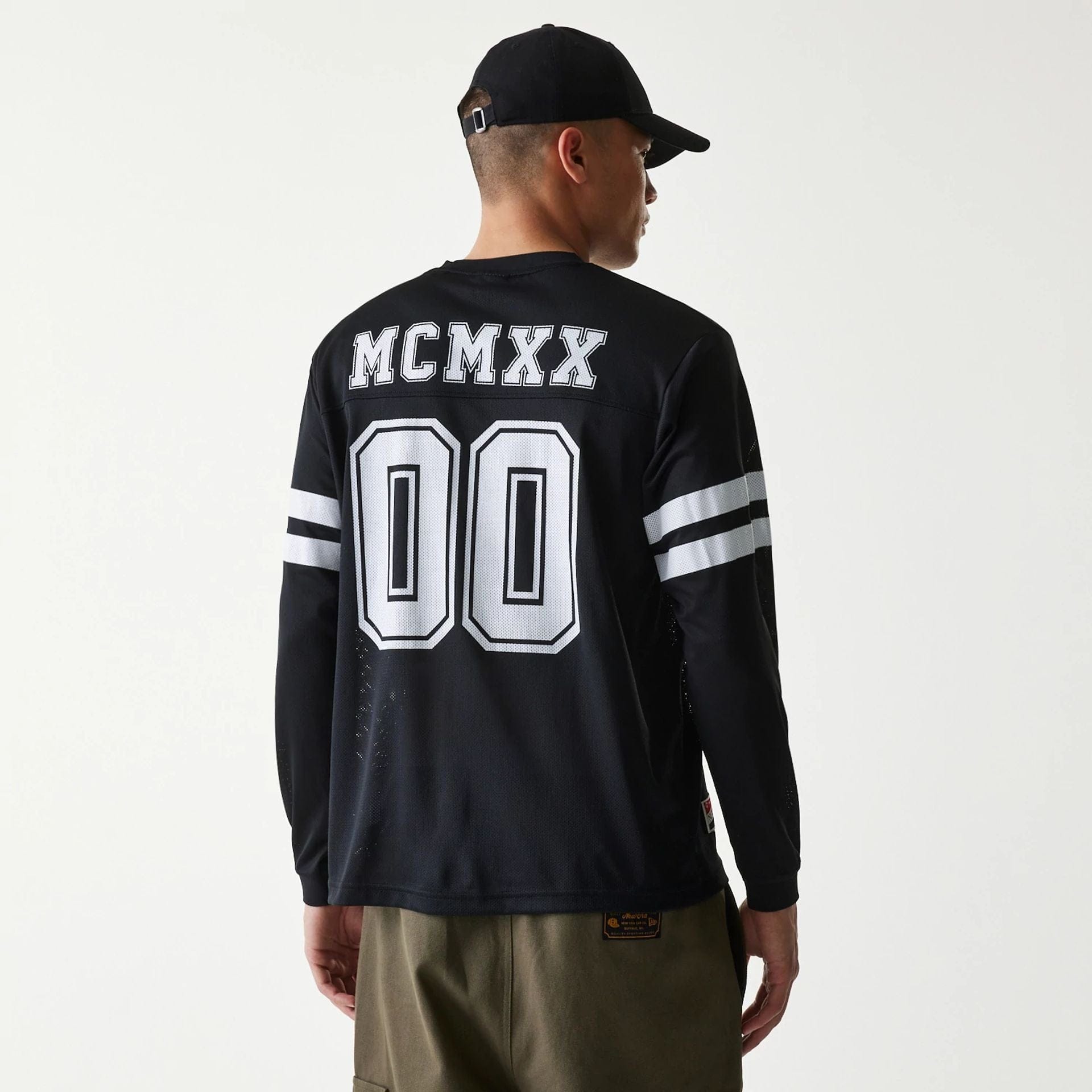 The Male model is wearing New Era Mesh Water Black Long Sleeve T-Shirt 2