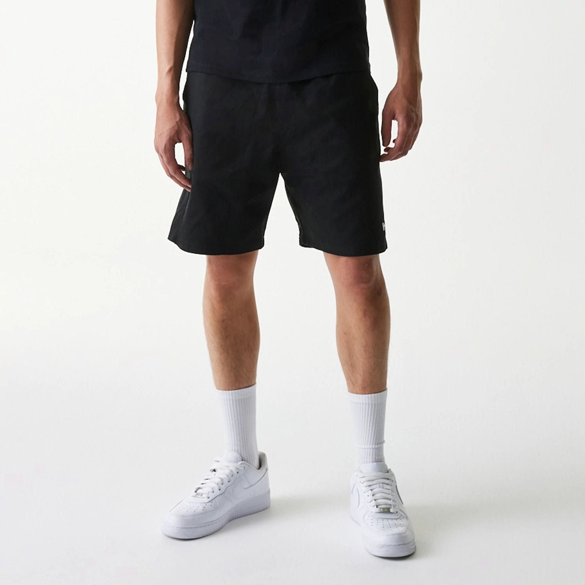 The Male model is wearing New Era Japan Woven Black Shorts 8