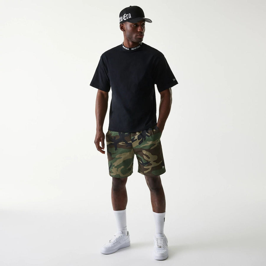 The Male model is wearing New Era Japan Neckband Logo Black T-Shirt 6