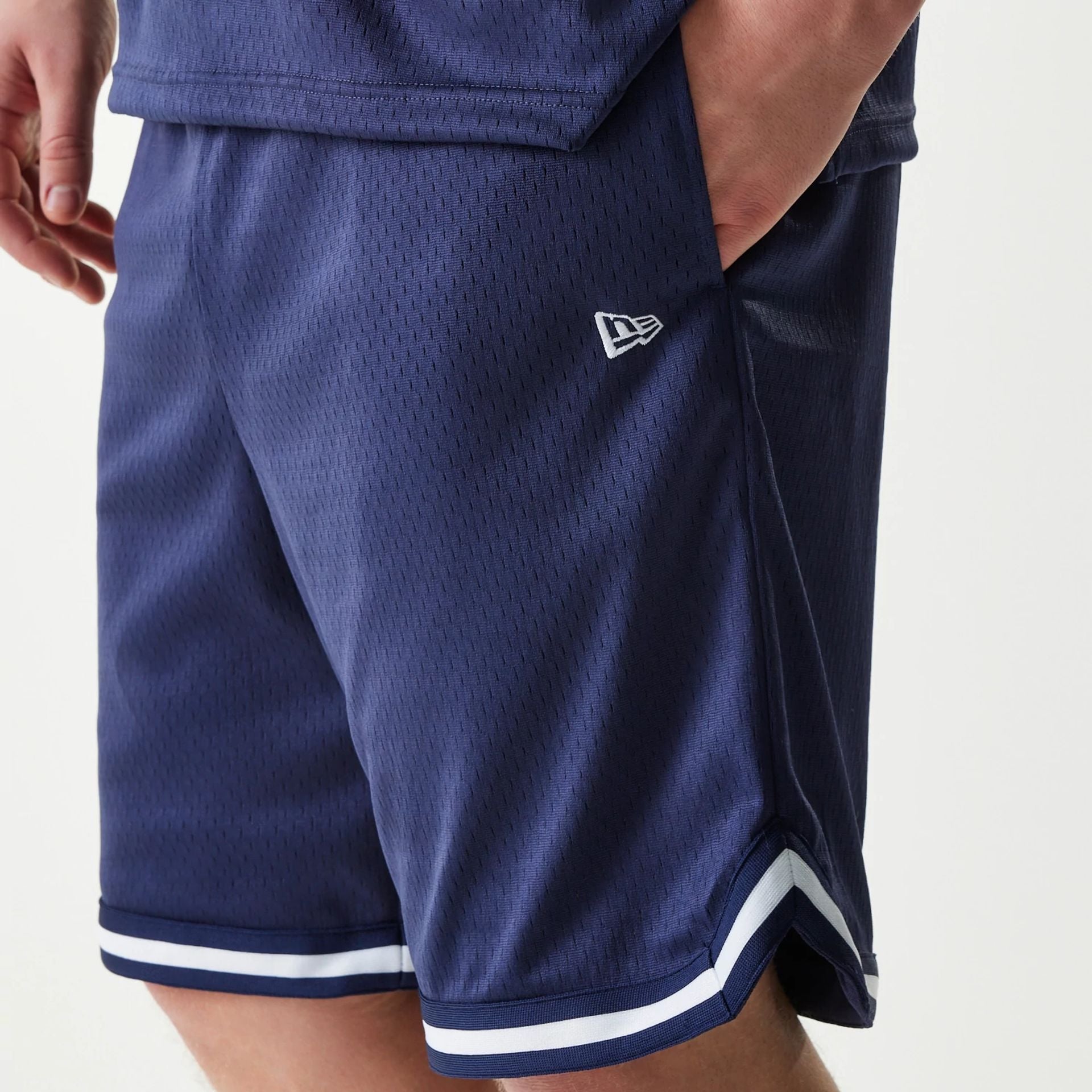 The Male model is wearing New Era Japan Mesh Navy Shorts 3