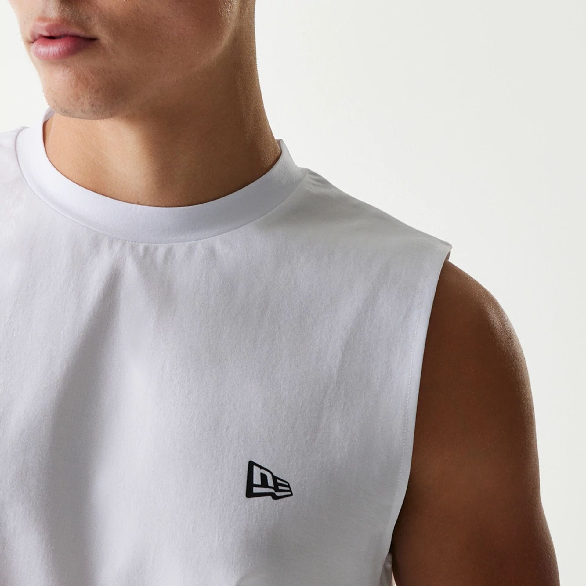 The Male model is wearing New Era Japan White Sleeveless T-Shirt 3