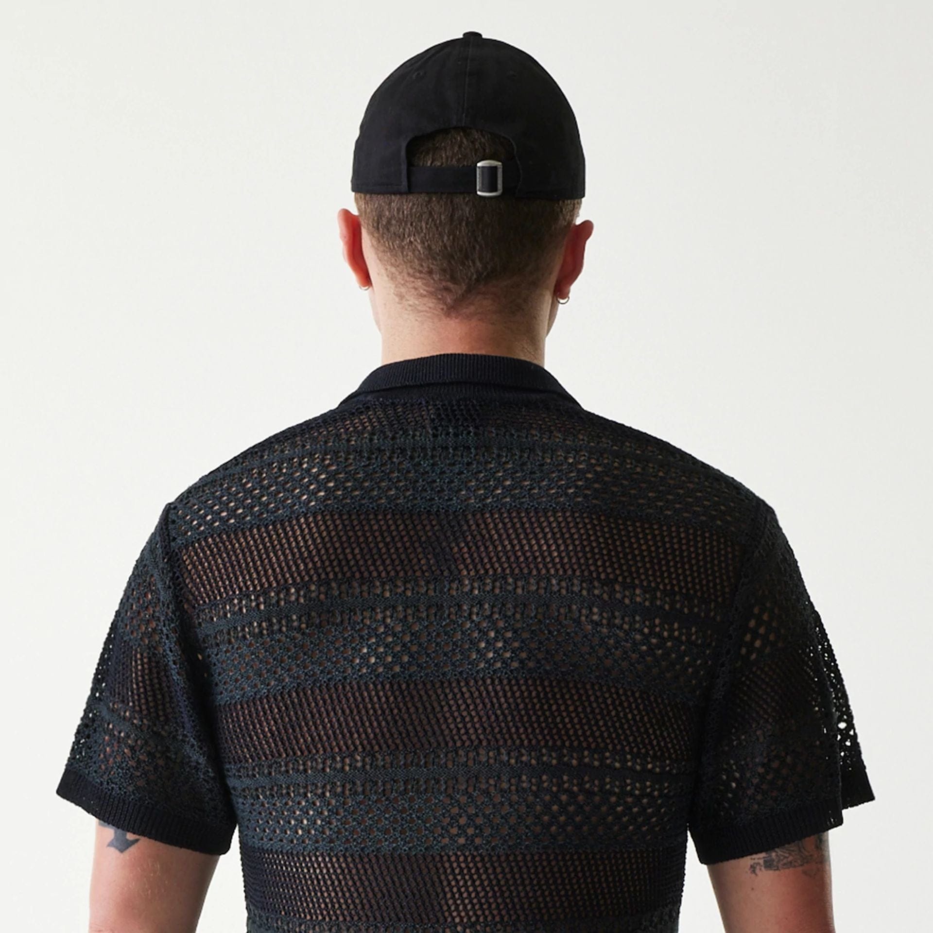 The Male model is wearing New Era Japan Mesh Black Polo T-Shirt 5