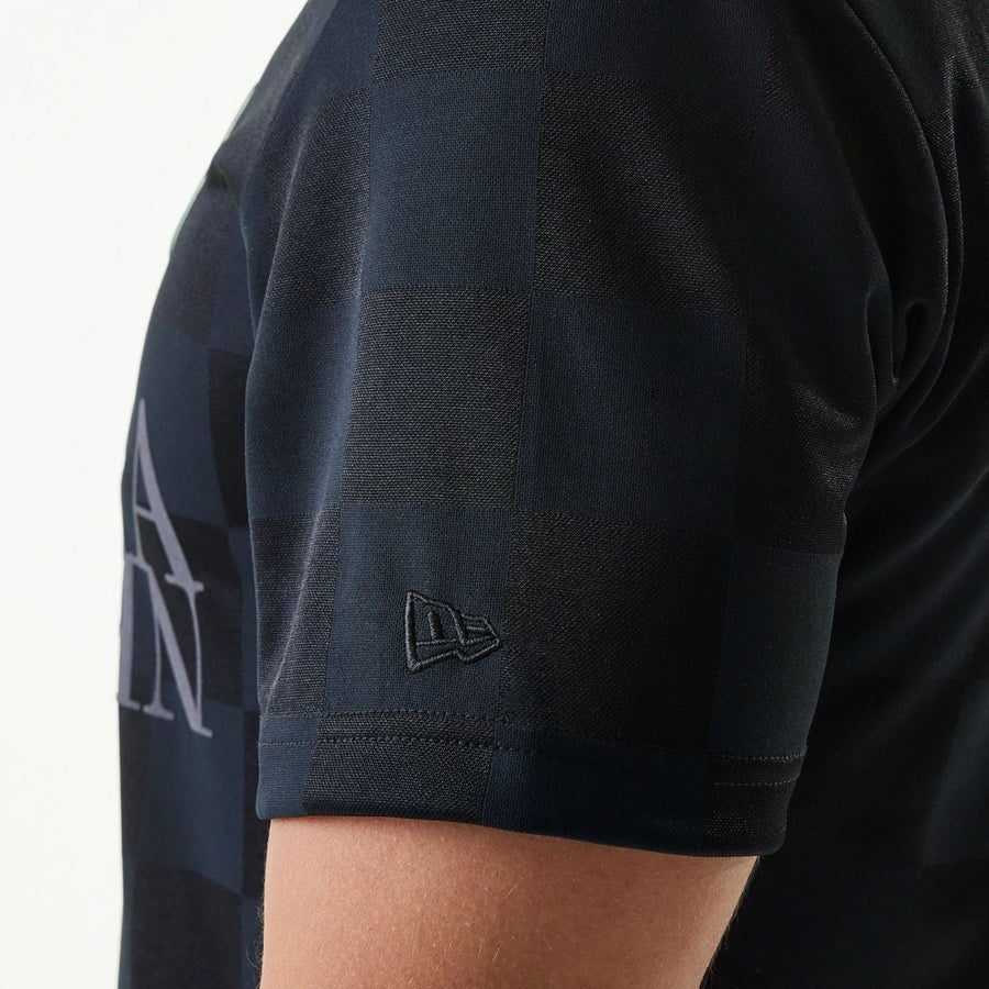 The Male model is wearing New Era Japan Grid Black Polo T-Shirt 4