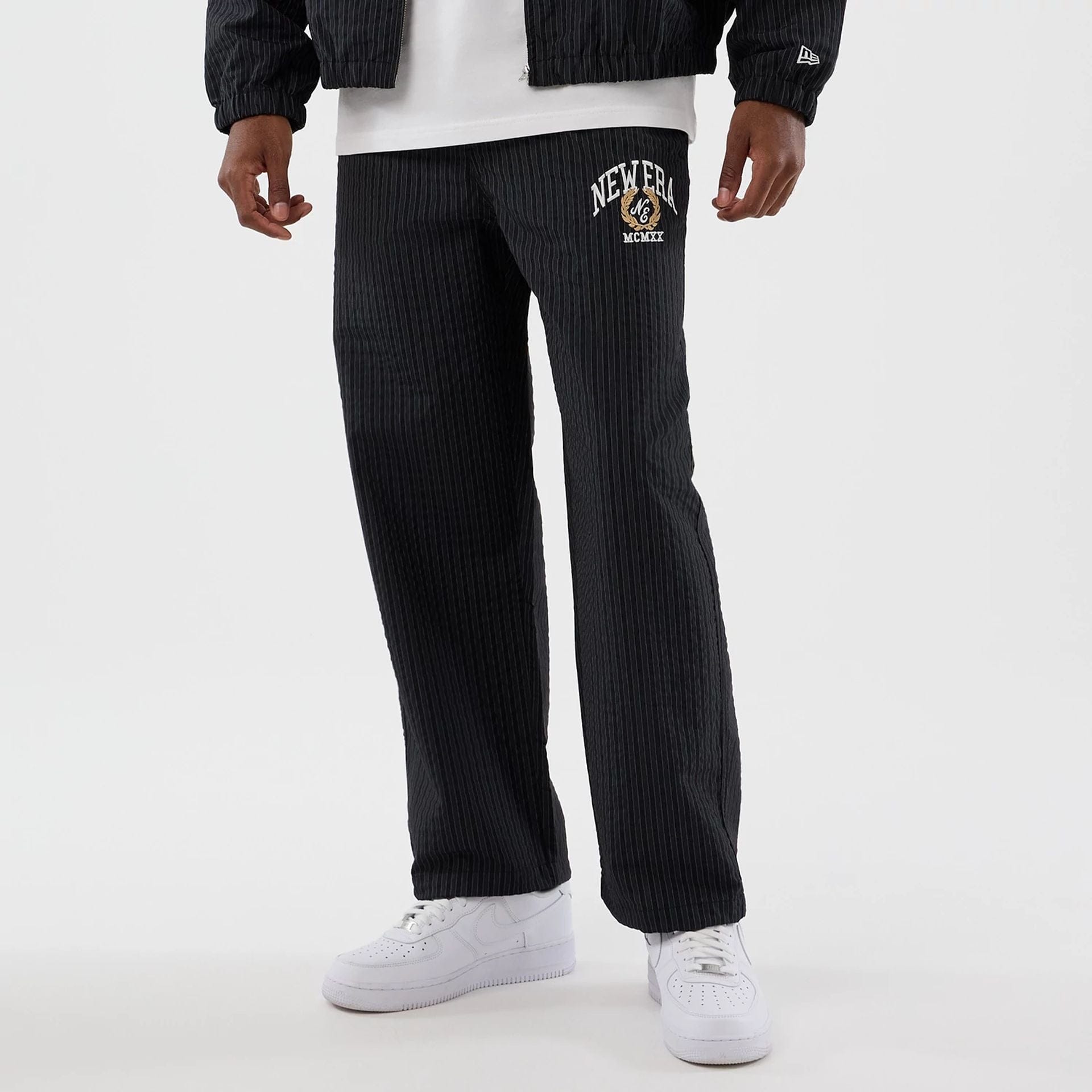 The model is wearing these New Era Street Class straight leg joggers in navy. 1
