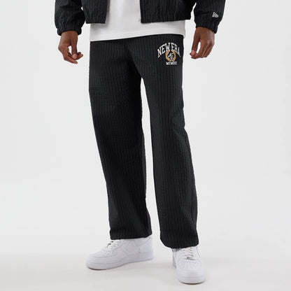The model is wearing these New Era Street Class straight leg joggers in navy. 1