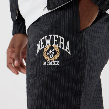 The model is wearing these New Era Street Class straight leg joggers in navy. 2