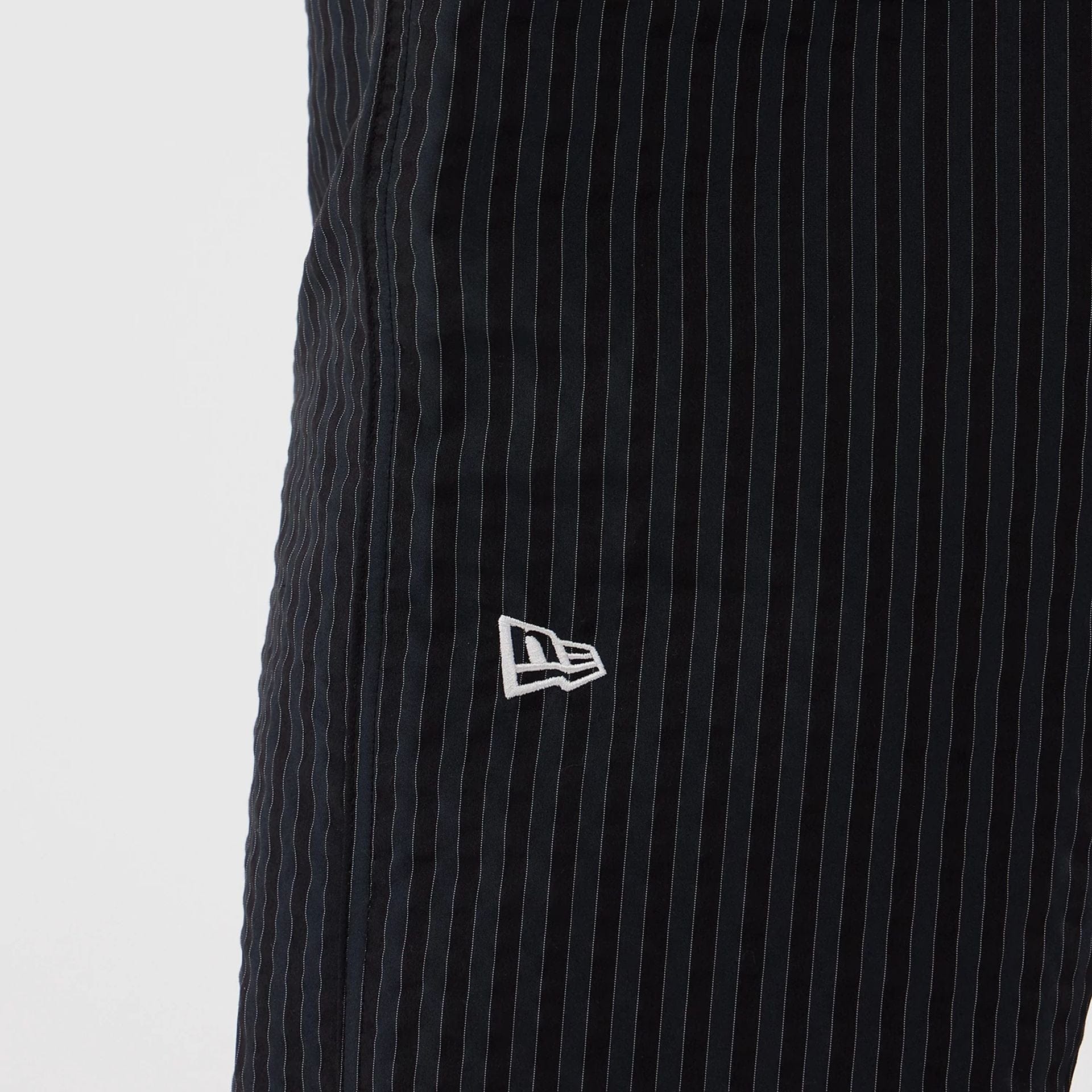 The model is wearing these New Era Street Class straight leg joggers in navy. 3