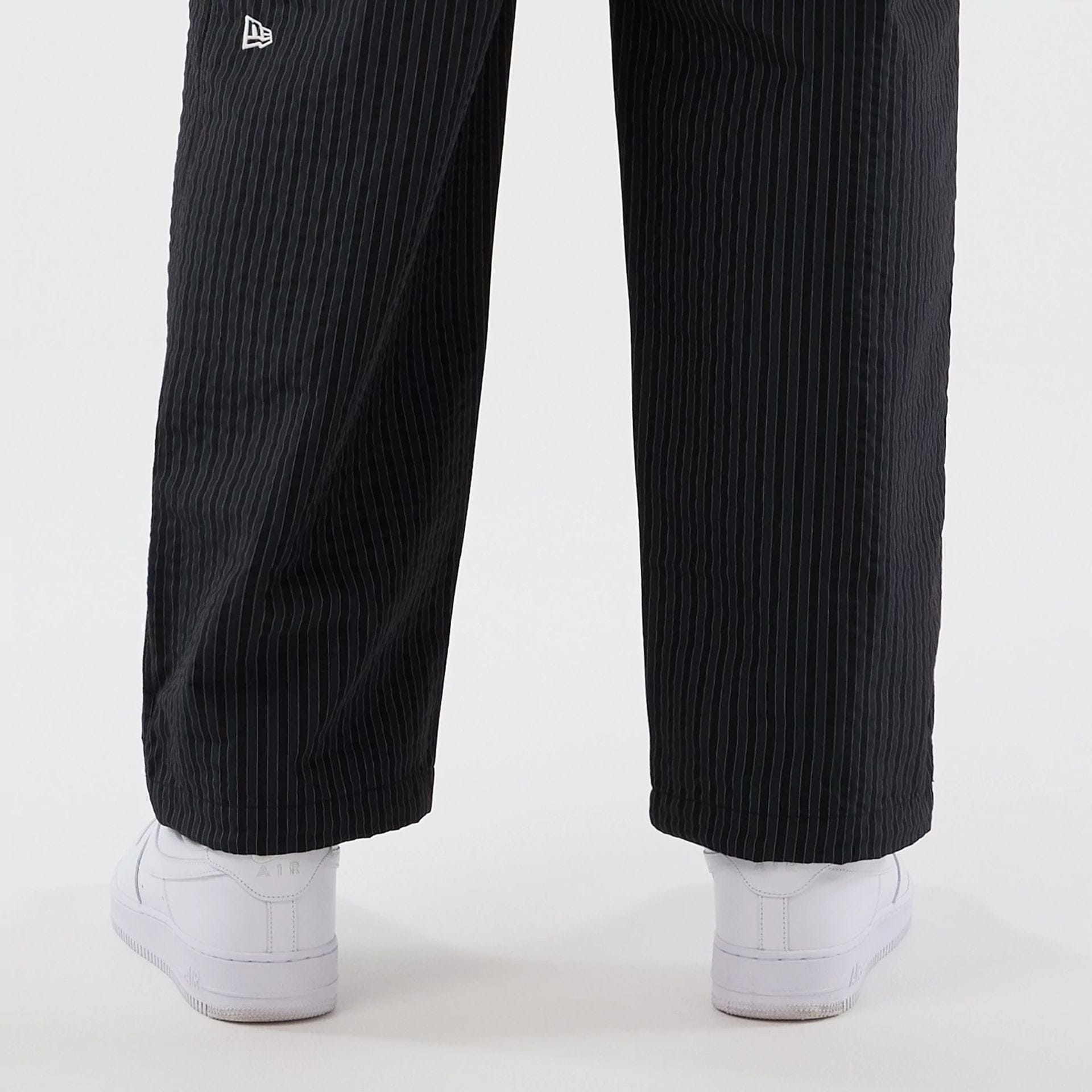 The model is wearing these New Era Street Class straight leg joggers in navy. 5