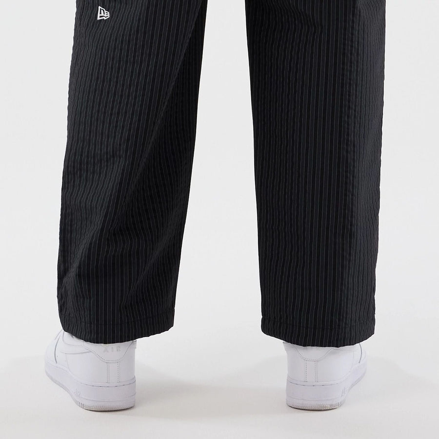 The model is wearing these New Era Street Class straight leg joggers in navy. 5