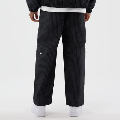 The model is wearing these New Era Street Class straight leg joggers in navy. 6