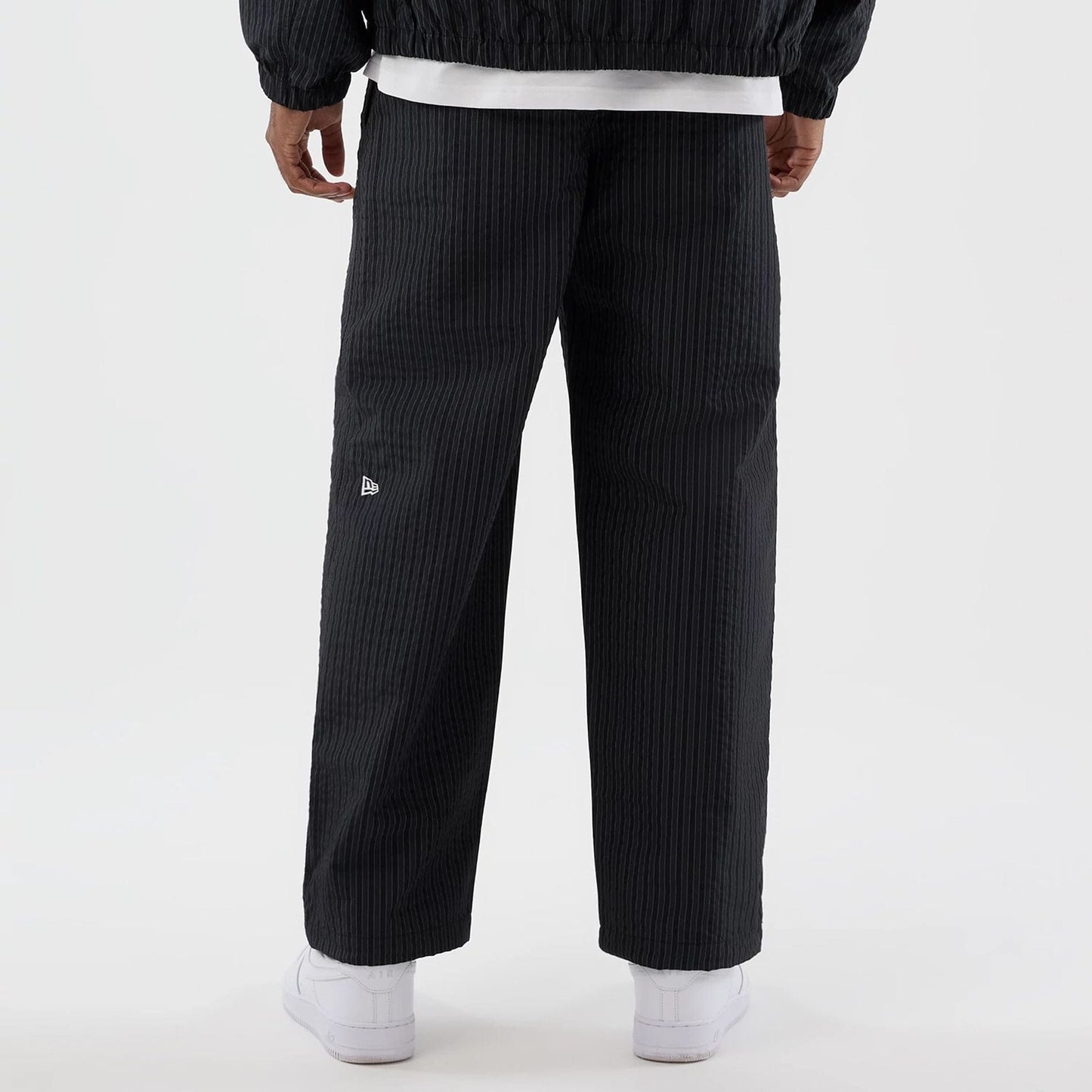 The model is wearing these New Era Street Class straight leg joggers in navy. 6