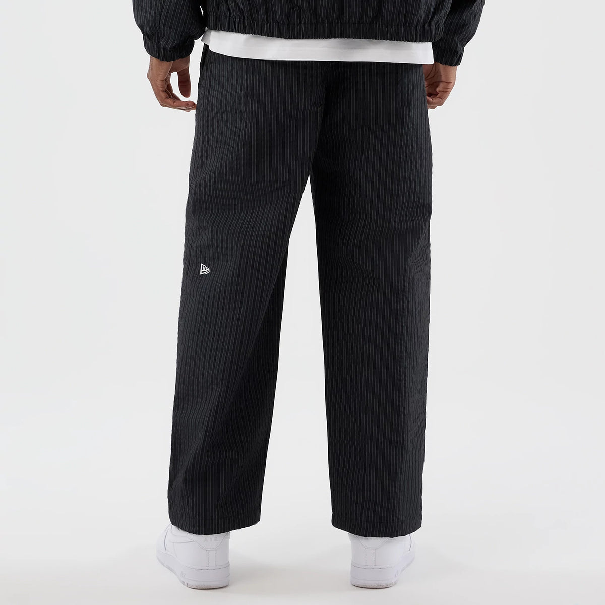 The model is wearing these New Era Street Class straight leg joggers in navy. 6