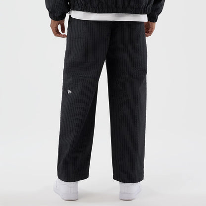 The model is wearing these New Era Street Class straight leg joggers in navy. 6