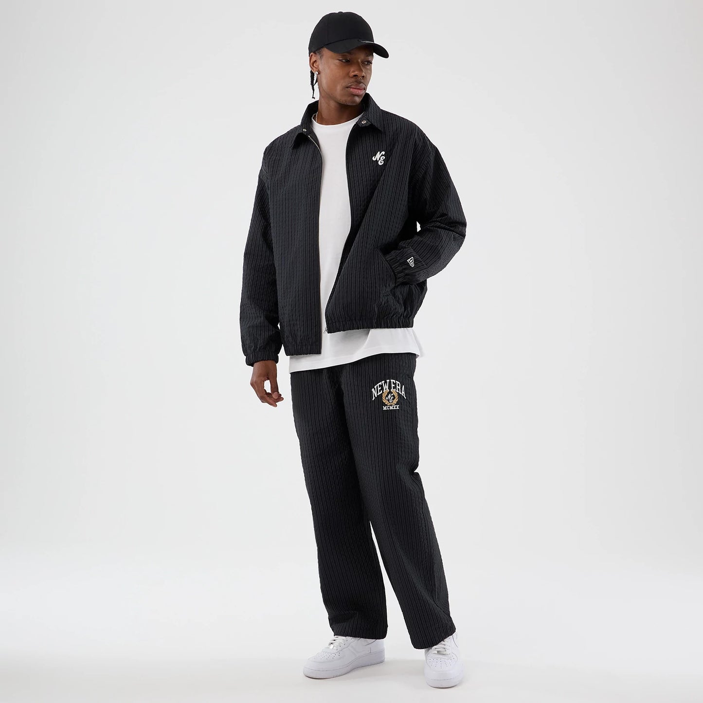 The model is wearing these New Era Street Class straight leg joggers in navy. 7