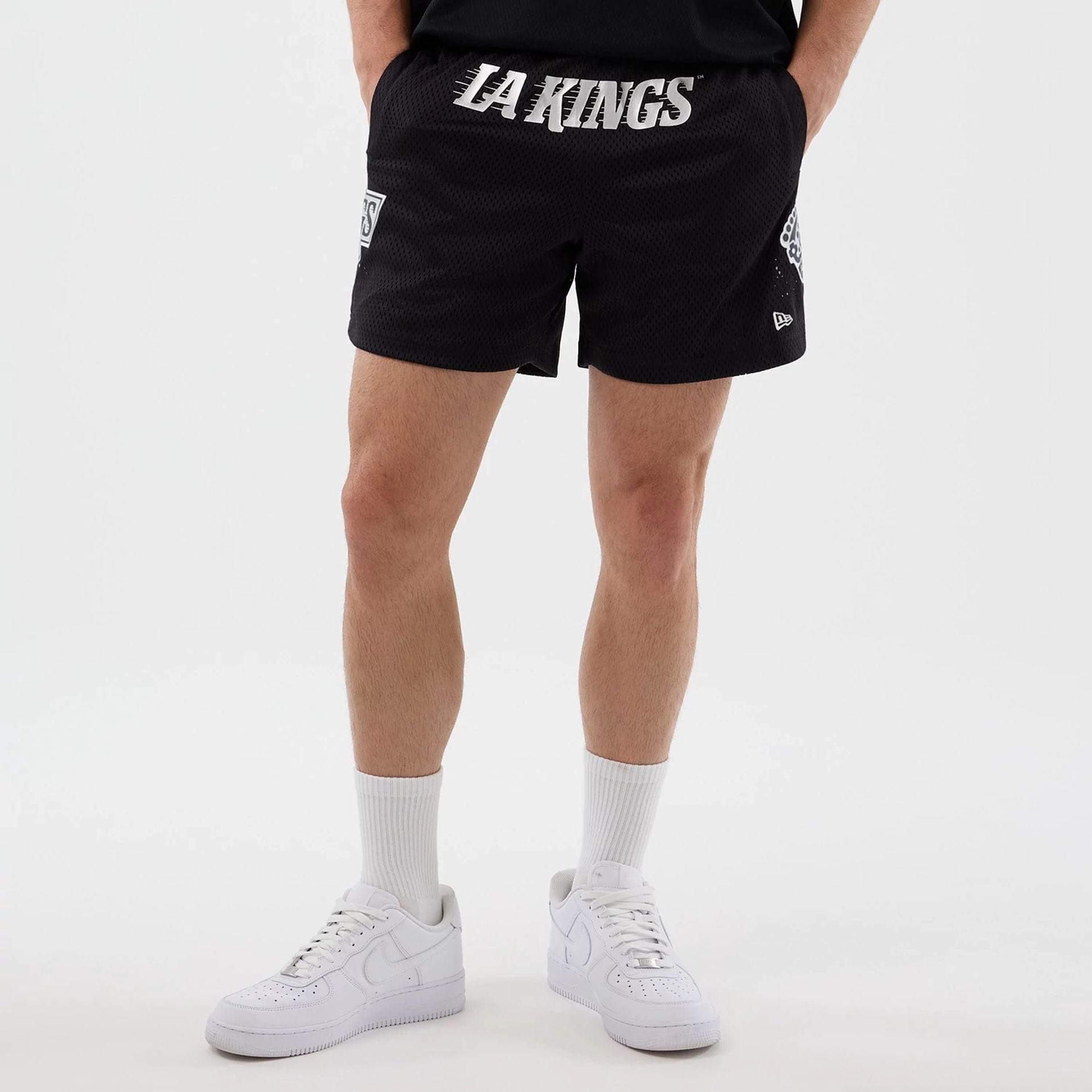 The Male model is wearing LA Kings NHL Street Culture Black Oversized Shorts  1