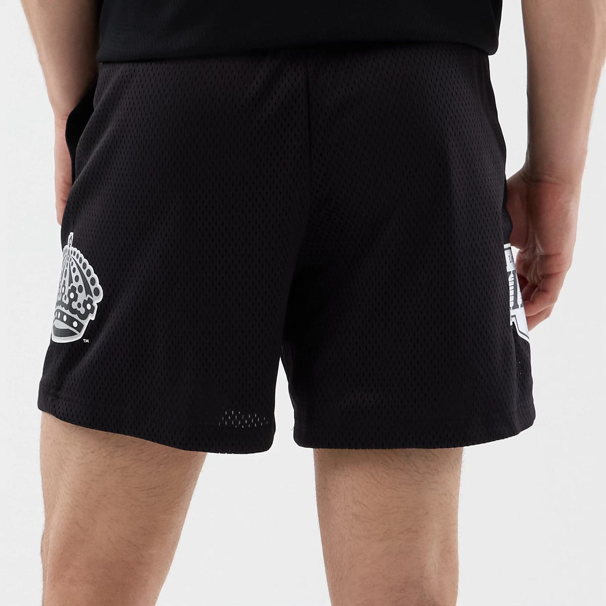 The Male model is wearing LA Kings NHL Street Culture Black Oversized Shorts 6