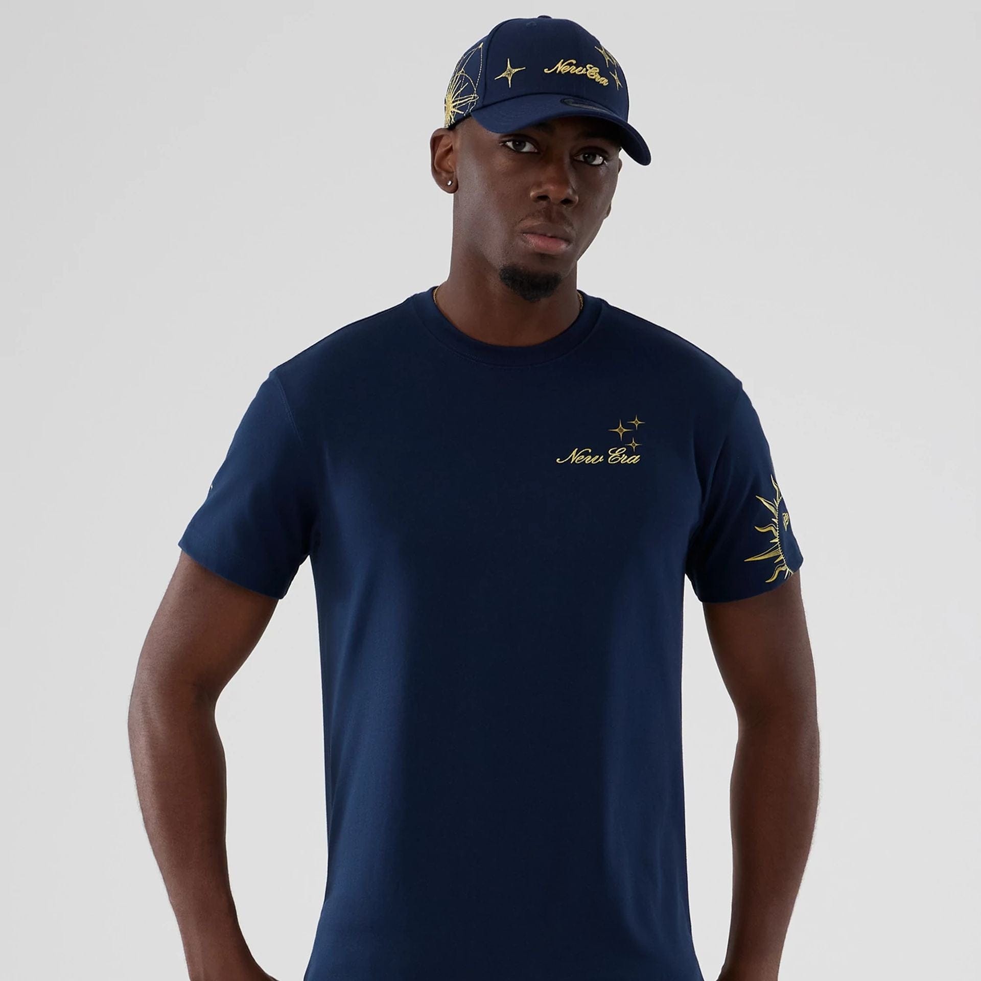 The model is wearing this New Era Cosmic Craft T-Shirt in blue. 7