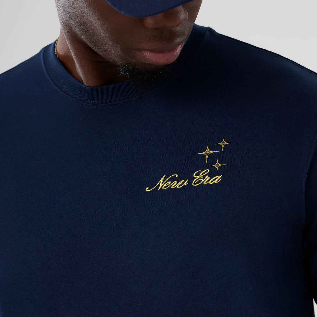 The model is wearing this New Era Cosmic Craft T-Shirt in blue. 3