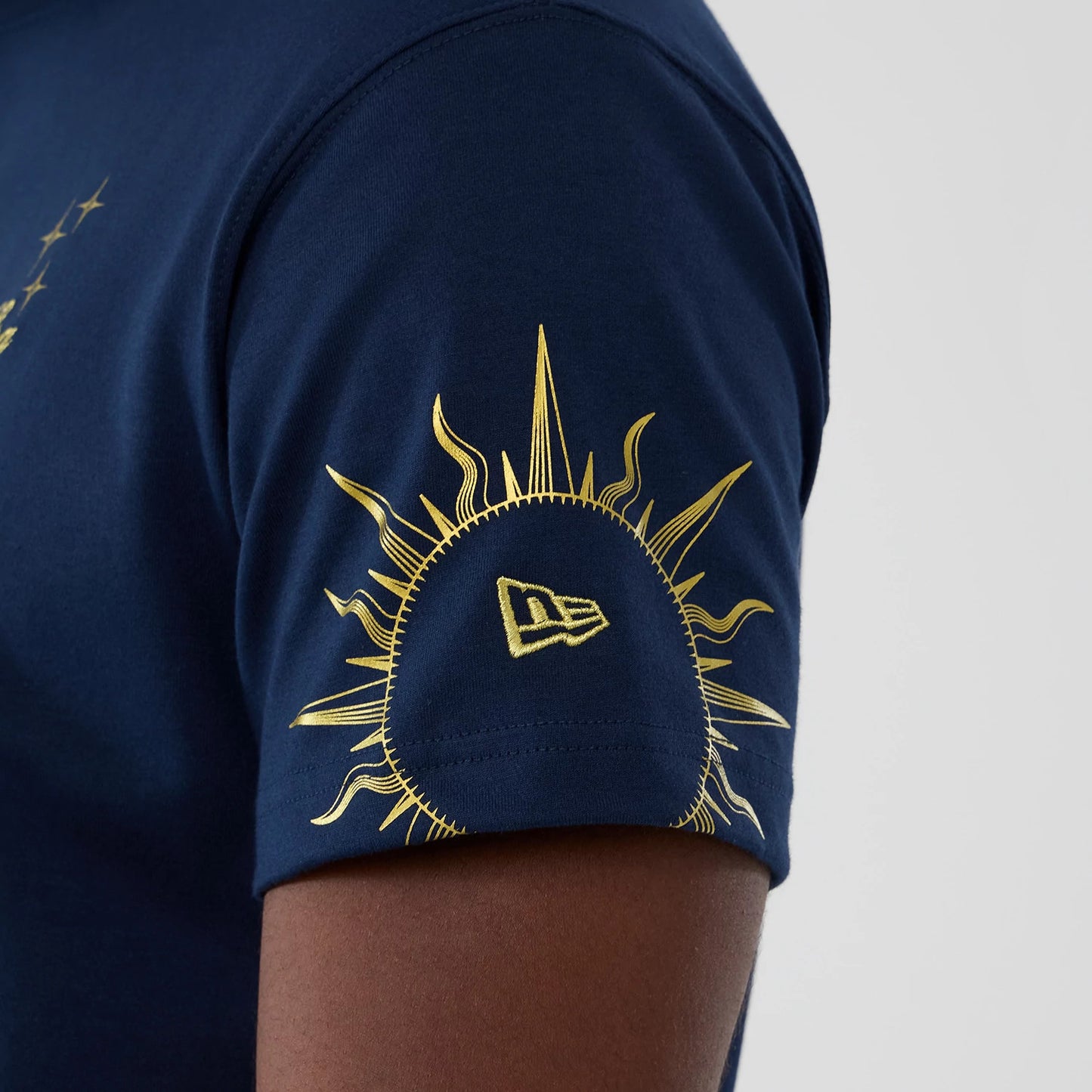 The model is wearing this New Era Cosmic Craft T-Shirt in blue. 4